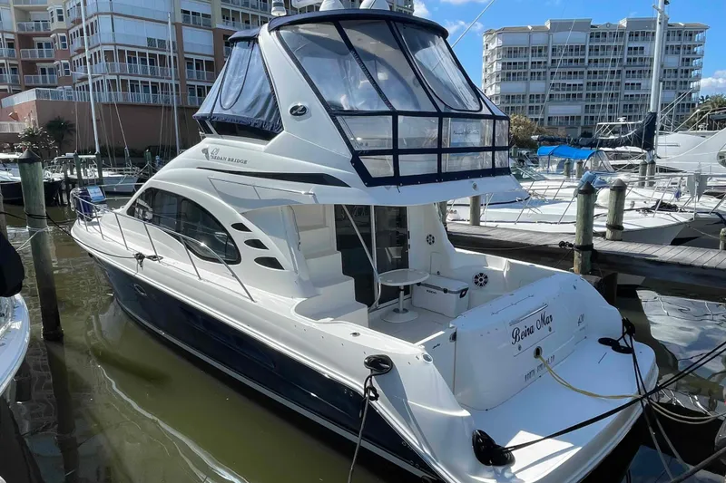 The Image of 2005 Sea Ray 420 Sedan Bridge yacht docked at marina, featuring sleek design and spacious deck. - 0
