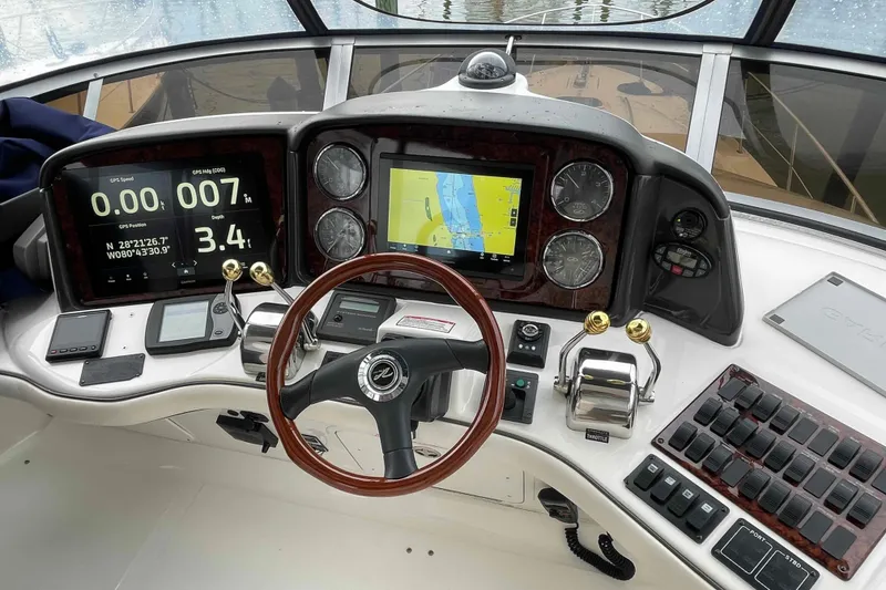 Slide: The Image of 2005 Sea Ray 420 Sedan Bridge helm with GPS, controls, and navigation displays. - 1