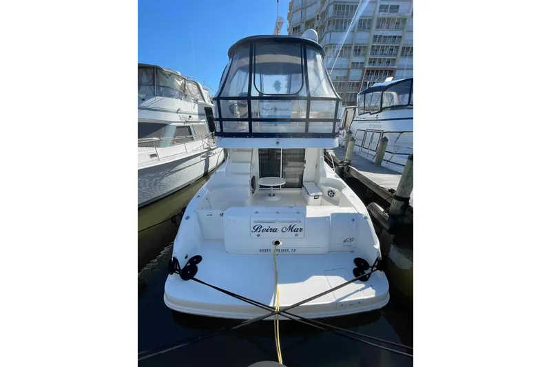 Slide: The Image of Open mini fridge on 2005 Sea Ray 420 Sedan Bridge yacht, showing interior shelving. - 102