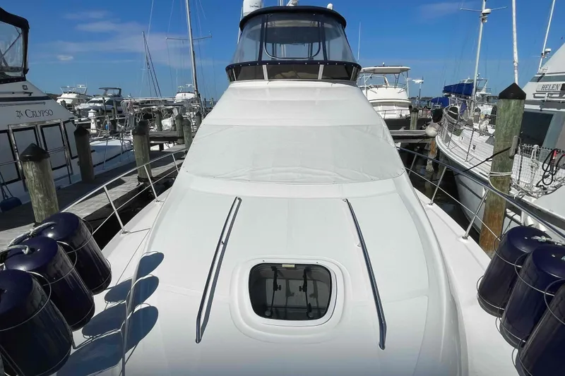 Slide: The Image of 2005 Sea Ray 420 Sedan Bridge yacht docked at marina, sunny day, clear blue sky. - 109
