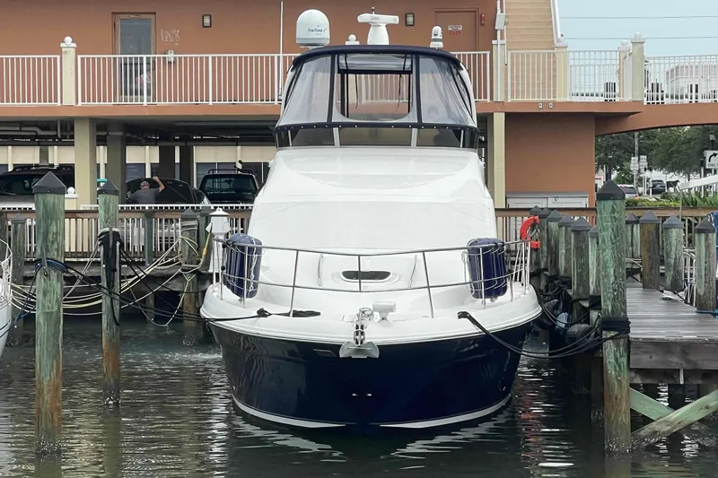 Slide: The Image of 2005 Sea Ray 420 Sedan Bridge yacht docked at marina, front view. - 110
