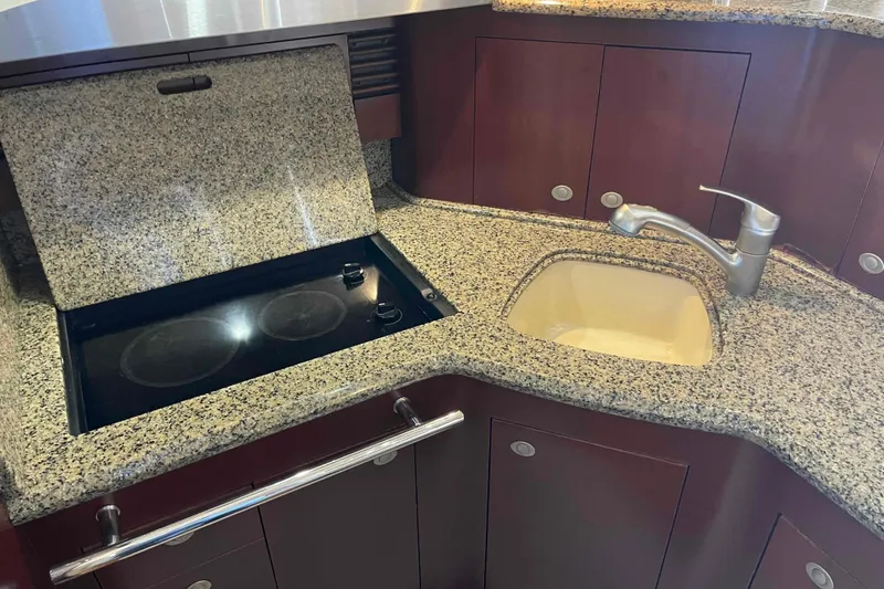 Slide: The Image of Luxurious kitchen area in 2005 Sea Ray 420 Sedan Bridge yacht with granite countertops. - 12