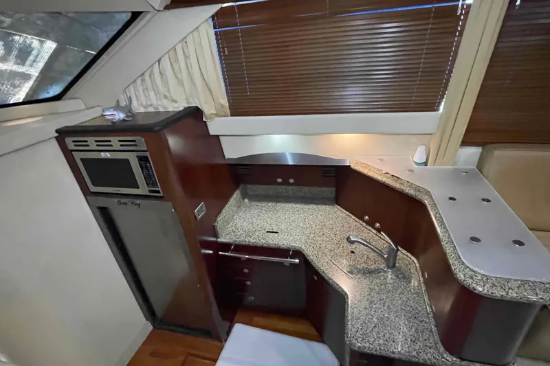 Slide: The Image of Granite countertop with stove and sink in 2005 Sea Ray 420 Sedan Bridge yacht. - 13