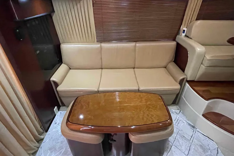 Slide: The Image of Luxurious interior of 2005 Sea Ray 420 Sedan Bridge with leather seating and elegant wood finishes. - 15