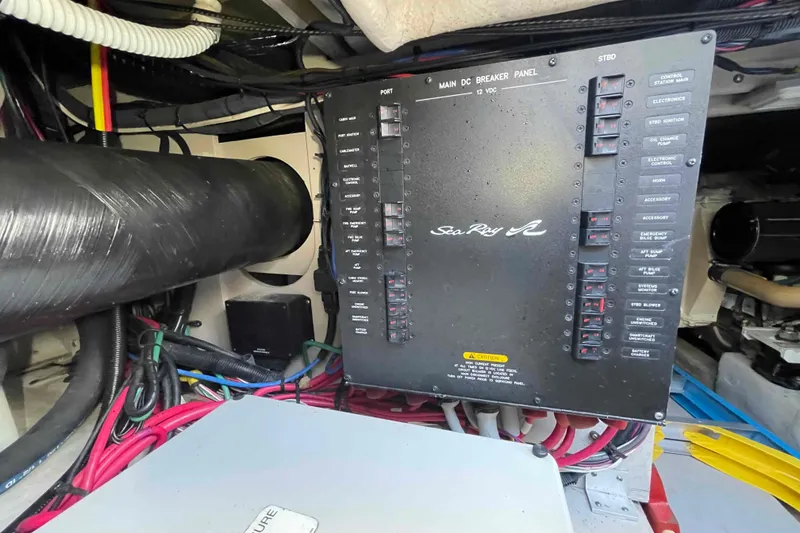 Slide: The Image of Engine compartment of 2005 Sea Ray 420 Sedan Bridge with batteries and equipment. - 43