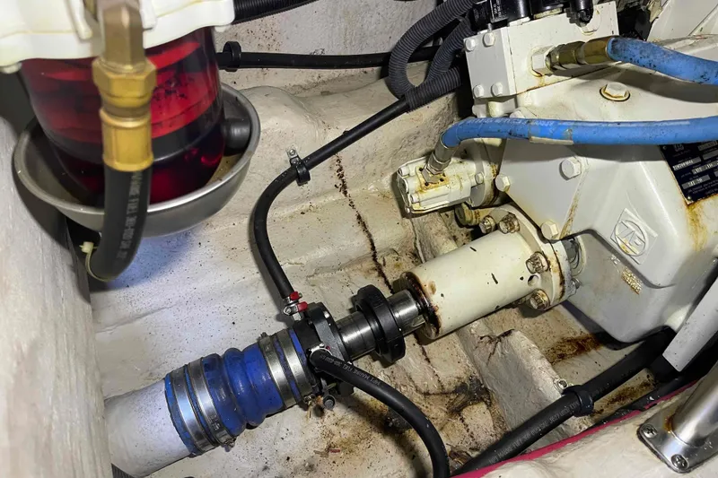 Slide: The Image of Battery setup in a 2005 Sea Ray 420 Sedan Bridge with red cables and safety labels. - 44