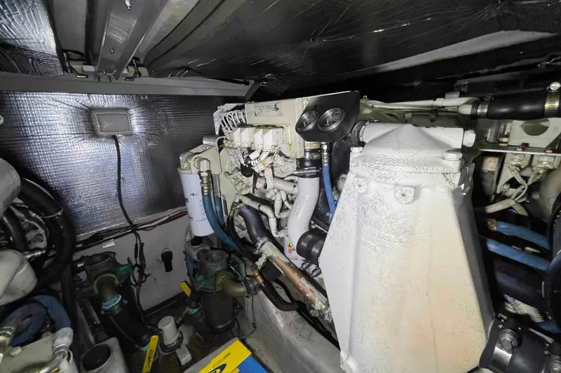 Slide: The Image of Engine room of 2005 Sea Ray 420 Sedan Bridge with visible wiring and equipment. - 47