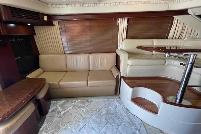 Slide: The Image of Luxurious interior of 2005 Sea Ray 420 Sedan Bridge with leather seating and wooden accents. - 6
