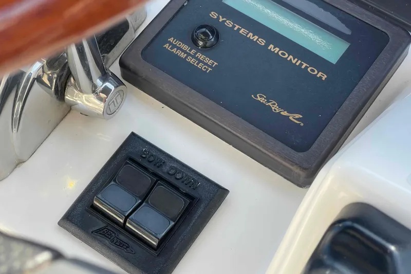 Slide: The Image of 2005 Sea Ray 420 Sedan Bridge cockpit with seating and table, docked by wooden posts. - 69