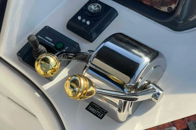 Slide: The Image of 2005 Sea Ray 420 Sedan Bridge helm with Garmin navigation system and wood-trimmed steering wheel. - 72