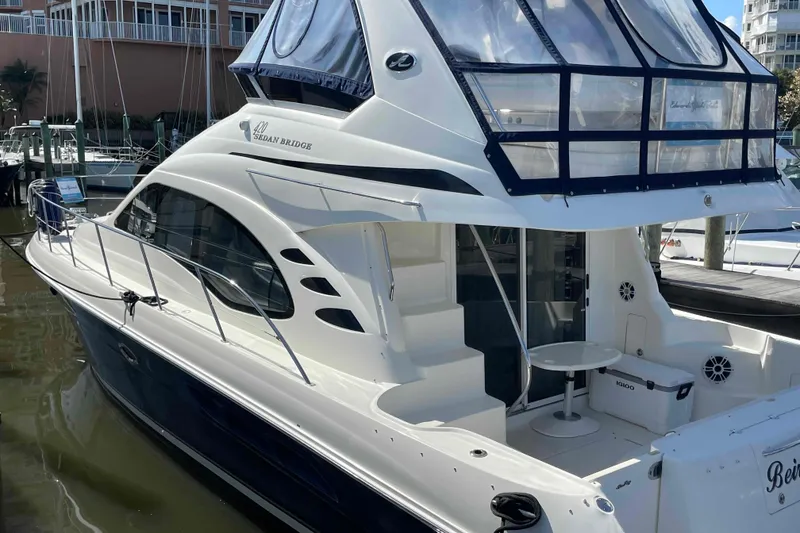 Slide: The Image of Captain's chair on 2005 Sea Ray 420 Sedan Bridge yacht, featuring luxurious white upholstery. - 87