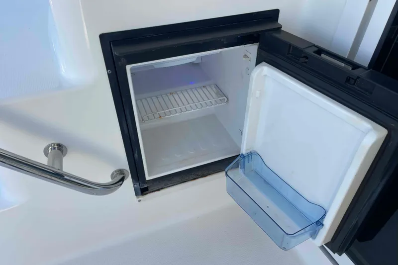 Slide: The Image of 2005 Sea Ray 420 Sedan Bridge helm with Garmin display and wood-accented steering wheel. - 92