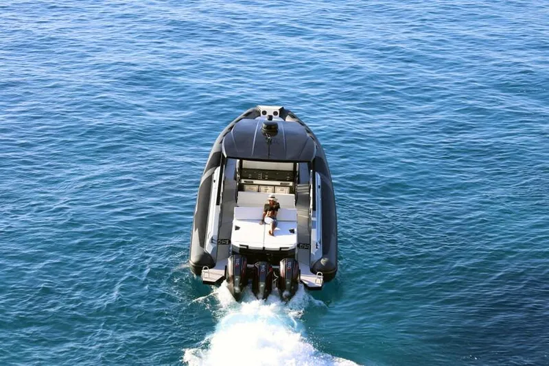 Slide: The Image of 2026 Ranieri Cayman 45.0 Executive cruising on open water, rear view. - 2