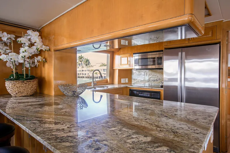 Slide: The Image of Luxurious kitchen interior of 2001 Hatteras 75 Cockpit Motor Yacht with granite countertops. - 10