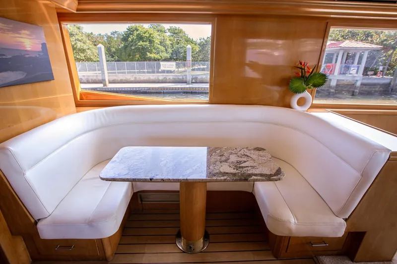 Slide: The Image of Luxurious interior of 2001 Hatteras 75 Cockpit Motor Yacht with elegant seating and table. - 12