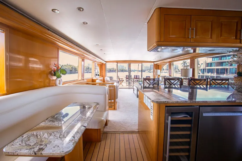 Slide: The Image of Luxurious interior of 2001 Hatteras 75 Cockpit Motor Yacht with elegant wood finishes. - 13