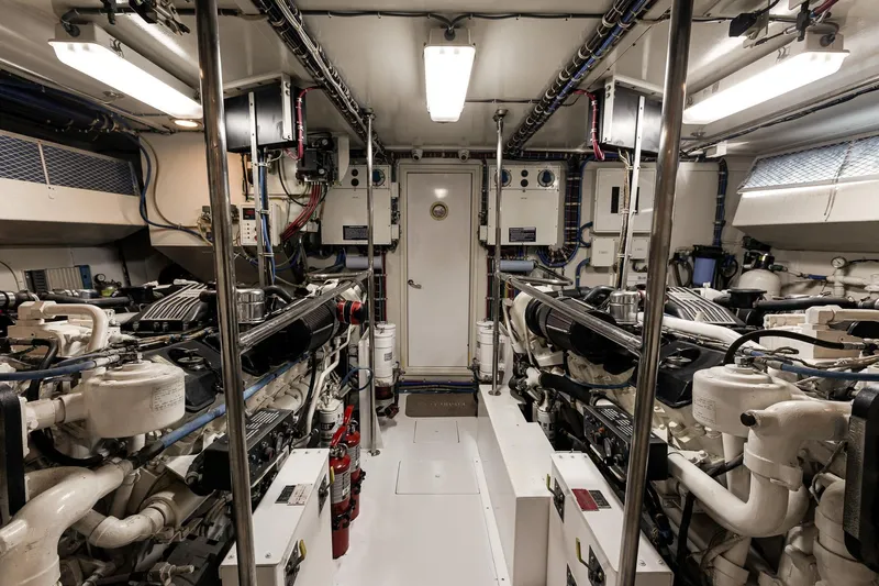 Slide: The Image of Engine room of 2001 Hatteras 75 Cockpit Motor Yacht, showcasing machinery and equipment. - 17