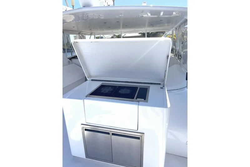 Slide: The Image of Outdoor kitchen on 2001 Hatteras 75 Cockpit Motor Yacht, featuring stainless steel appliances. - 2