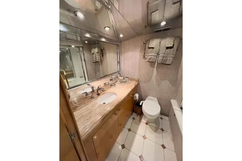 Slide: The Image of Luxurious bathroom in 2001 Hatteras 75 Cockpit Motor Yacht with marble countertop and modern fixtures. - 20