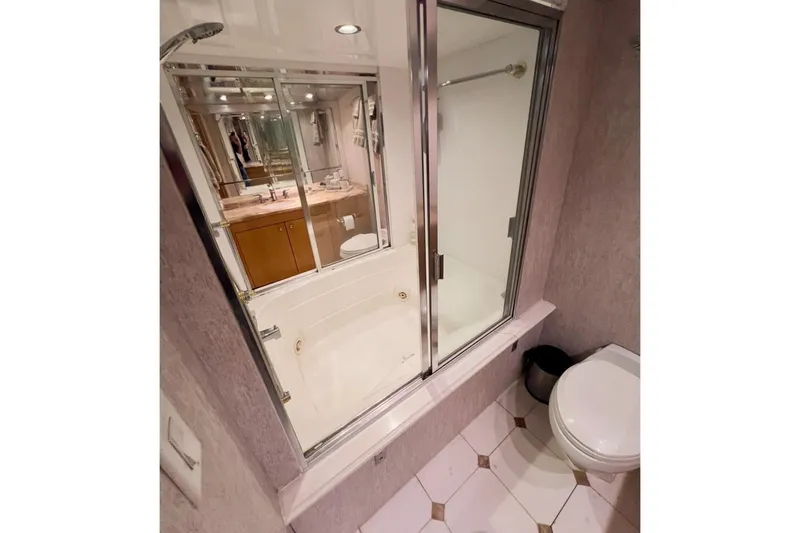Slide: The Image of Luxurious bathroom in 2001 Hatteras 75 Cockpit Motor Yacht with shower and toilet. - 21