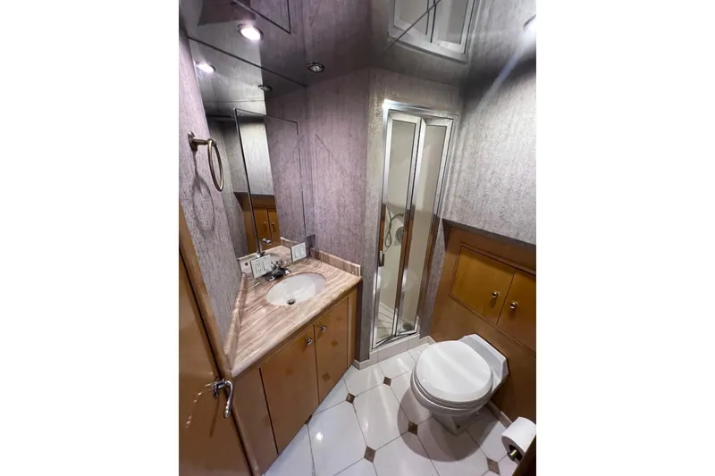 Slide: The Image of Luxurious bathroom in 2001 Hatteras 75 Cockpit Motor Yacht with shower and vanity. - 25