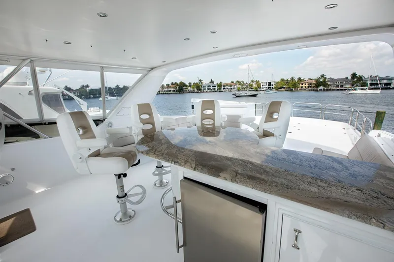 Slide: The Image of Luxurious 2001 Hatteras 75 Cockpit Motor Yacht interior with elegant seating and scenic water view. - 30