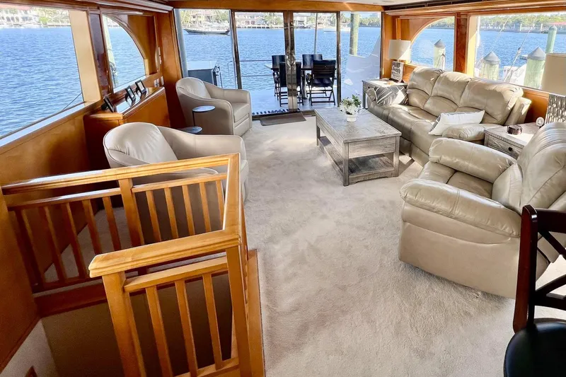 Slide: The Image of Luxurious interior of 2001 Hatteras 75 Cockpit Motor Yacht with plush seating and scenic water views. - 8
