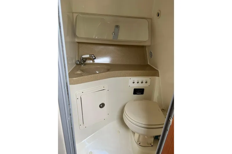 Slide: The Image of 2006 Hydra-Sports Vector 3300 VX boat with open storage compartment and visible engines. - 10