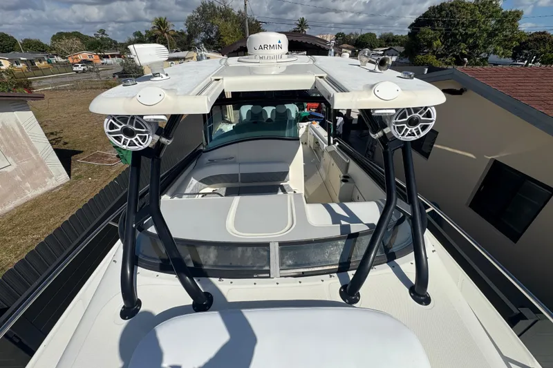 Slide: The Image of 2006 Hydra-Sports Vector 3300 VX boat with speakers and radar, docked in a residential area. - 19