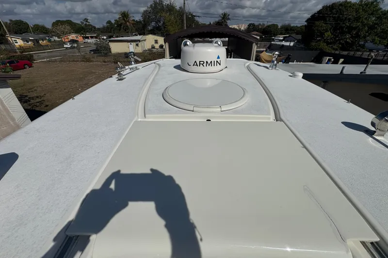 Slide: The Image of 2006 Hydra-Sports Vector 3300 VX boat deck with Garmin equipment, under a partly cloudy sky. - 20