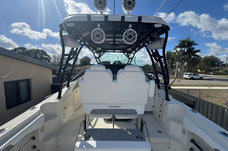 Slide: The Image of 2006 Hydra-Sports Vector 3300 VX boat with seating and overhead speakers, under a sunny sky. - 21
