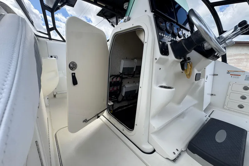 Slide: The Image of 2006 Hydra-Sports Vector 3300 VX boat cockpit with open storage compartment and steering wheel. - 22