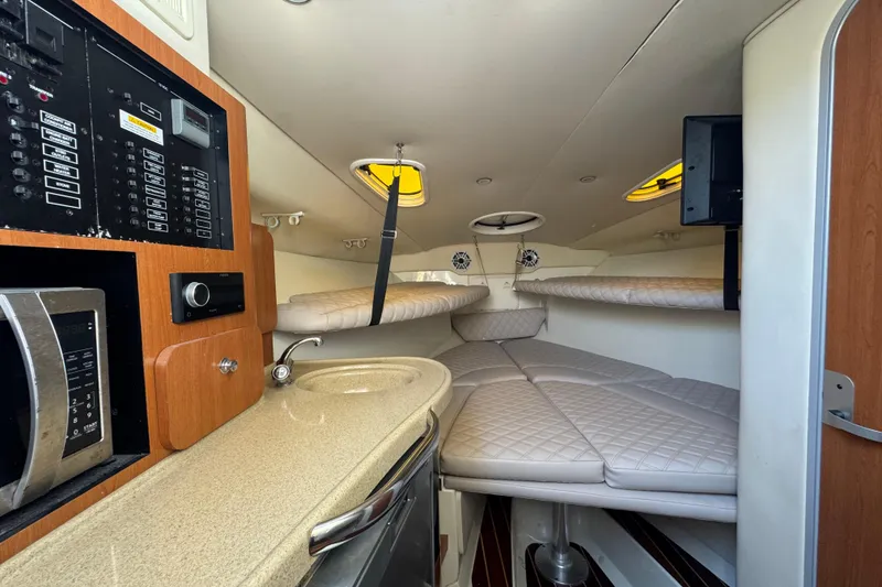 Slide: The Image of 2006 Hydra-Sports Vector 3300 VX cabin interior with kitchenette and sleeping area. - 24