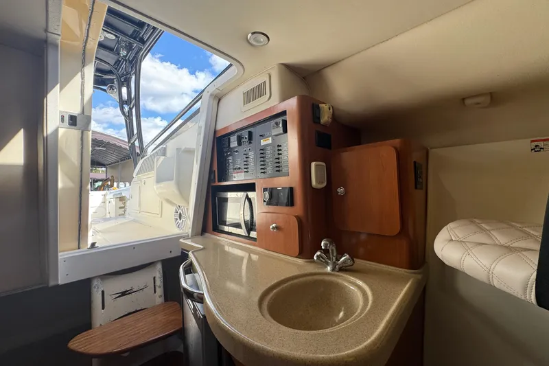 Slide: The Image of 2006 Hydra-Sports Vector 3300 VX cabin interior with sink, microwave, and control panel. - 25