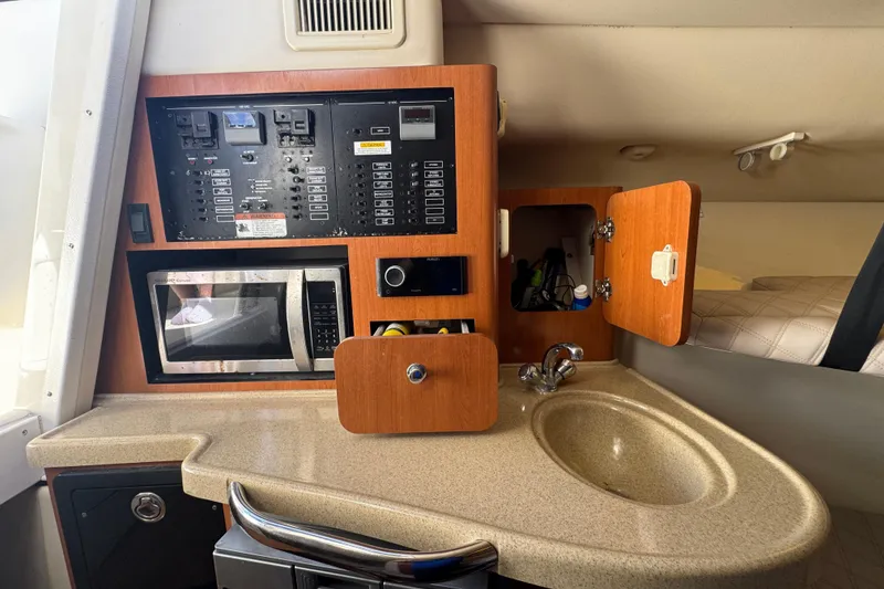Slide: The Image of 2006 Hydra-Sports Vector 3300 VX cabin with control panel, microwave, and sink. - 26