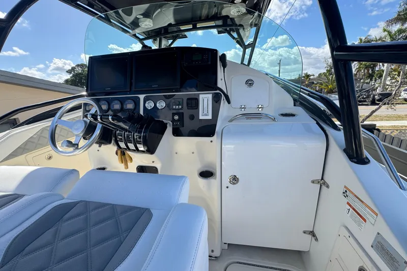 Slide: The Image of 2006 Hydra-Sports Vector 3300 VX boat cockpit with steering wheel and control panel. - 39