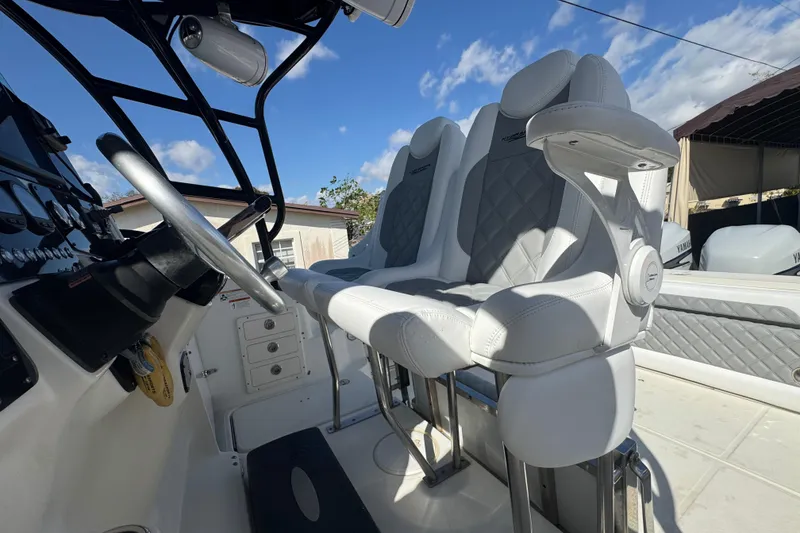 Slide: The Image of 2006 Hydra-Sports Vector 3300 VX boat interior with steering wheel and cushioned seats. - 40