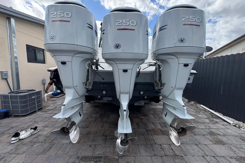 Slide: The Image of 2006 Hydra-Sports Vector 3300 VX with triple 250 horsepower outboard engines, parked on a paved driveway. - 44