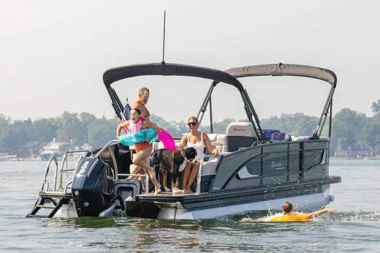 The Image of Manufacturer Provided Image: 2026 Barletta Lusso 25UE pontoon boat with people and dog enjoying a sunny day on the water. - 0