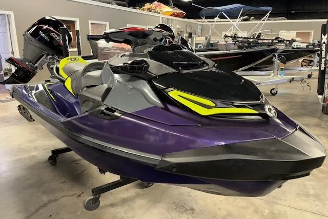 The Image of 2021 Sea-Doo RXT-X 300 jet ski in showroom, featuring sleek design and vibrant colors. - 1