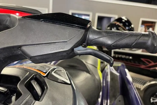 Slide: The Image of Close-up of 2021 Sea-Doo RXT-X 300 handlebar and controls in showroom. - 14