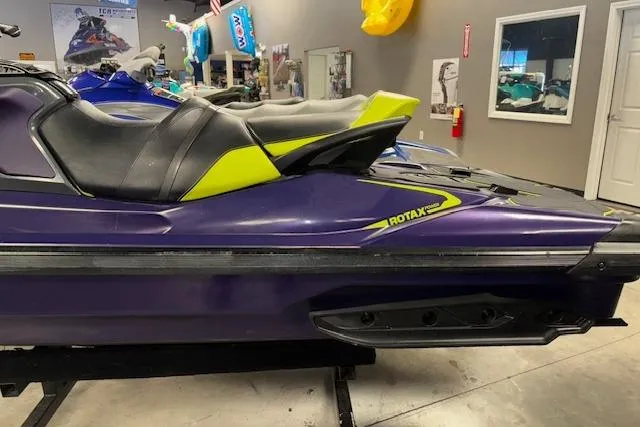 Slide: The Image of 2021 Sea-Doo RXT-X 300 jet ski in showroom, featuring sleek purple and yellow design. - 4