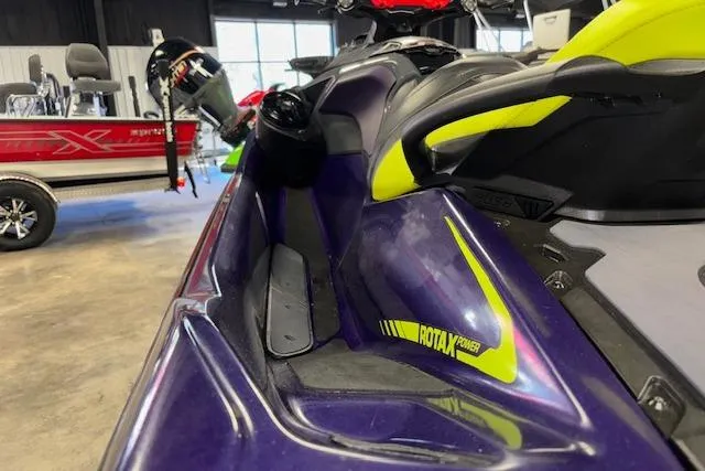 Slide: The Image of 2021 Sea-Doo RXT-X 300 jet ski, purple and yellow, in showroom. - 6