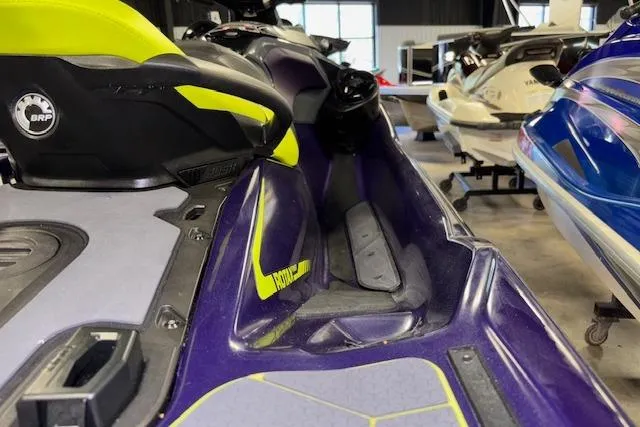 Slide: The Image of 2021 Sea-Doo RXT-X 300 jet ski in a showroom, featuring vibrant purple and yellow design. - 7