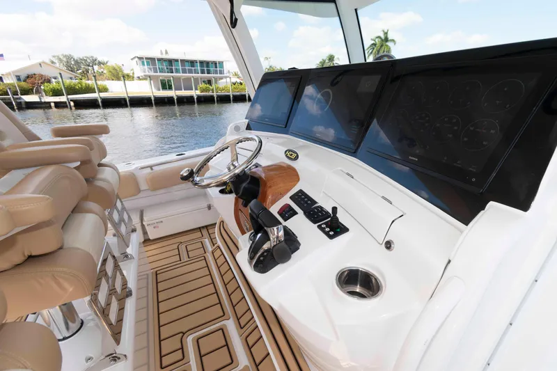 Slide: The Image of Luxurious helm of 2021 HCB 53 Sueños boat with advanced navigation displays. - 12