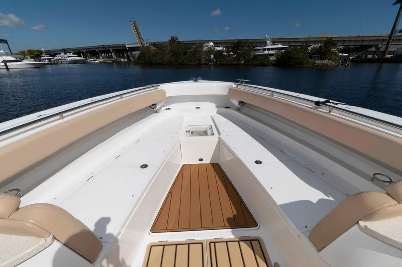 Slide: The Image of 2021 HCB 53 Sueños boat interior with beige seating and wooden deck. - 20