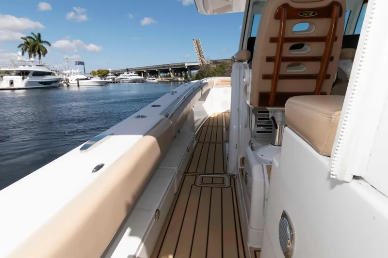 Slide: The Image of 2021 HCB 53 Sueños boat interior with beige seating and wooden deck. - 21