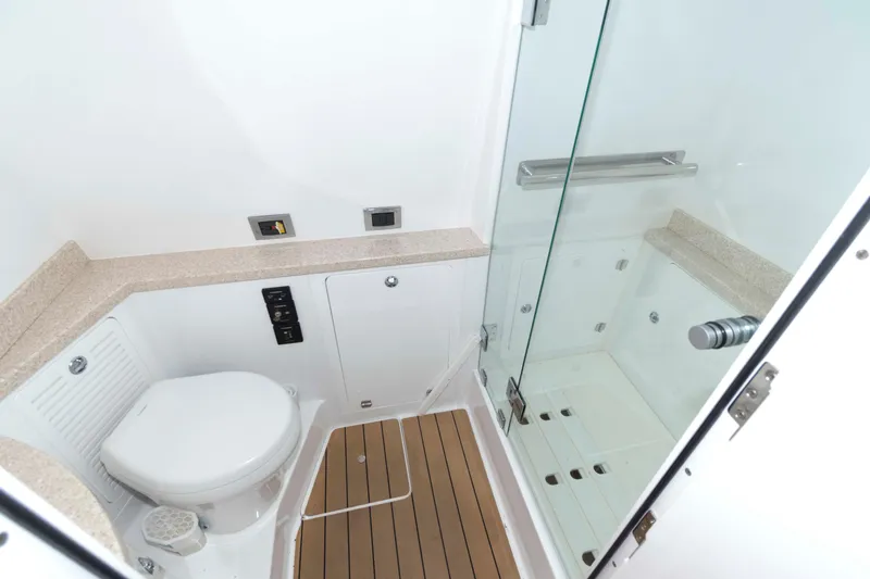 Slide: The Image of 2021 HCB 53 Sueños boat with spacious seating, docked under a clear blue sky. - 30