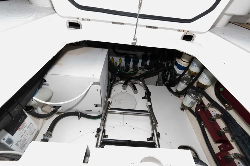 Slide: The Image of Open storage compartment on 2021 HCB 53 Sueños boat, featuring clean white interior. - 35