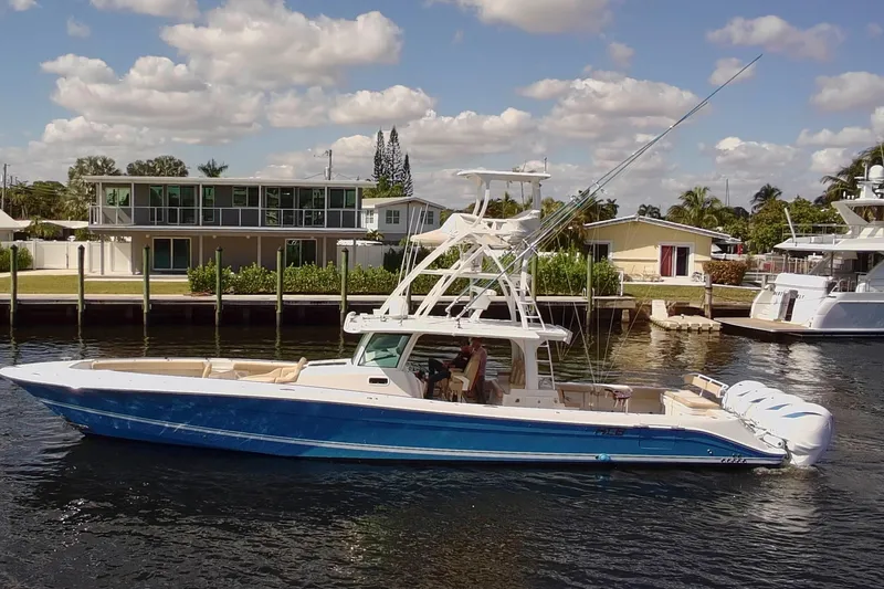 The Image of 2021 HCB 53 Sueños boat cruising on a sunny day near waterfront homes. - 0